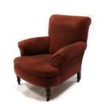 A Howard & Son style upholstered armchair n turned front supports.