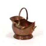 A copper coal scuttle.