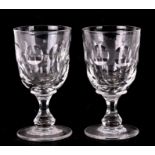 A pair of 19th century glasses with faceted stems and ground out pontil mark, 16cms (6.25ins)