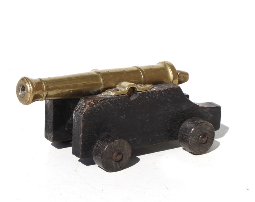 An early 20th century signal cannon with a brass or possibly bronze barrel mounted on a wooden