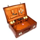 A gentleman's fitted suitcase with silver topped bottles and ivory backed brushes.Condition Report