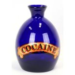 A large cobalt blue vase with gilt lettering 'Cocaine', 31cms (12ins) high.