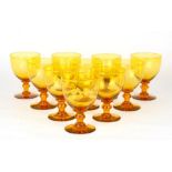 A set of ten 19th century amber glasses with knopped stem and snapped off pontil mark, 15cms (