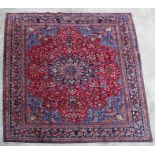 A Persian Mashad woollen hand knotted carpet with central floral medallion within floral borders, on