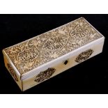 A 19th century Cantonese Export carved ivory glove box highly carved with figural panels and foliate