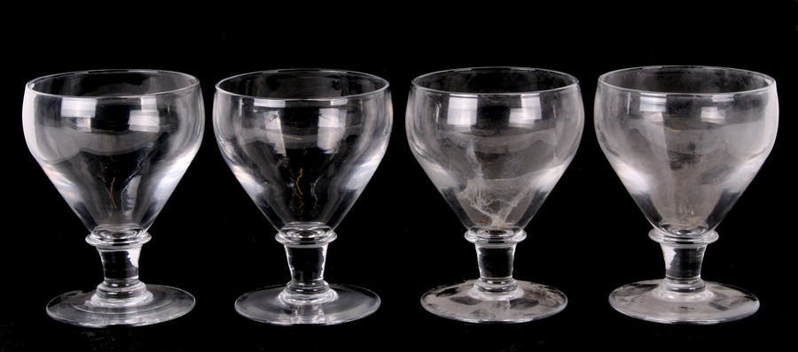 A set of four wine glasses with snapped off pontil mark, 17cms (6.75ins) high (4).Condition