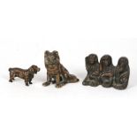 A bronze figure of a spaniel; together with a bronze figure of a seated dog; and a bronze group of