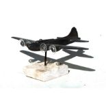 An aluminium model of the American WW2 Flying Fortress aircraft mounted on a marble base. Wingspan