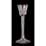 An 18th / 19th century air twist wine glass, the bowl cut with lily of the valley, the stem with
