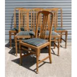 A set of six oak dining chairs with drop-in seats and turned front supports.