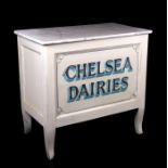 A white painted shop cabinet with rectangular faux marble top, stencilled 'Chelsea Dairies',