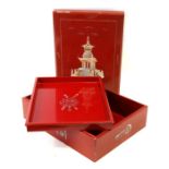 A Chinese lacquer box decorated with a pagoda in mother of pearl on a red ground, 40cms (15.75ins)