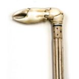 A carved whale bone walking stick with carved ivory handle in the form of a crabs claw.93cm (36.5