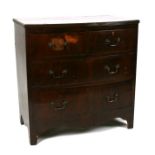 A mahogany bowfronted chest of two short and two long graduated drawers, 75cms (29.5ins) wide.