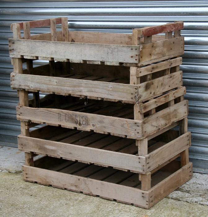 A group of five wooden apple crates.