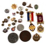 A quantity of enamel badges, medals and buttons.