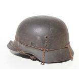 A WW2 Third Reich helmet with liner and chin strap. Marked inside SE66 & 4704