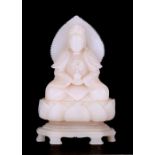 A Chinese alabaster seated figure on a lotus flower base, 23cms (9ins) high.