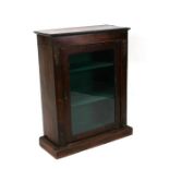 A 19th century mahogany Pier cabinet with single glazed door and shelved interior, on a plinth base,