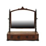 A 19th century mahogany toilet mirror with three drawers, on bun feet, 58cms (22.75ins) wide.