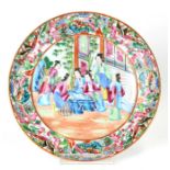 A 19th century Chinese Canton Export plate decorated with figures within a foliate and bird