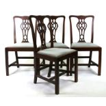 A set of four mahogany dining chairs with pierced back splats and drop-in upholstered seats, on