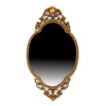 A gilt framed oval wall mirror, 89cms (35ins) high..