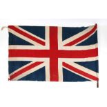 A huge early 20th century wall hanging patriotic Union Jack printed cotton flag on its wooden