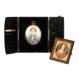 A late 19th century oval portrait miniature depicting an old lady, cased; together with an