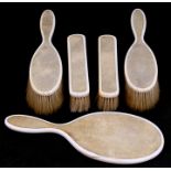 An early 20th century shagreen and ivory dressing table set consisting of a hand mirror and four