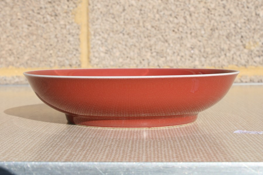 A Chinese red monochrome glaze shallow dish with blue seal mark to the underside, 19cms (7.5ins) - Image 3 of 14