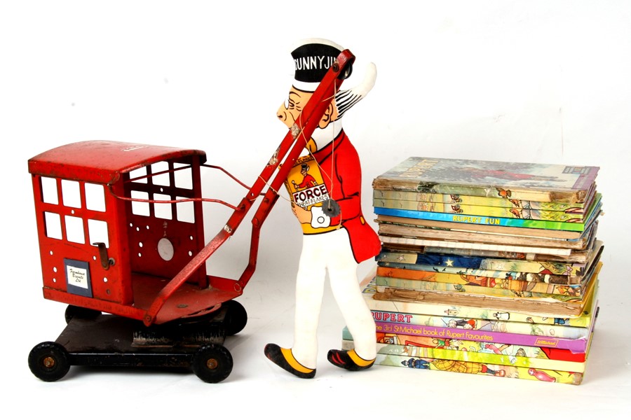 A quantity of children's books and annuals; together with a toy crane.