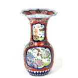 A Japanese Imari vase decorated with birds and flowers within panels, six character red mark to