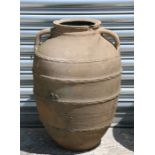 A large two handled terracotta olive jar, 60cm (23.75ins) high