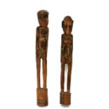 African / Tribal Art. A pair of African carved hardwood tribal figures, the largest 71cm (28ins)