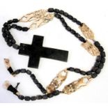 An ethnic wooden and bone bead necklace with stone crucifix pendant