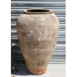A large terracotta olive jar, 72cm (28.25ins) high
