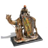 A Bergman style painted spelter table lighter in the form of rug seller and a camel, 18cm (7ins)