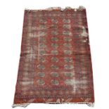 A Persian Turkoman rug with three rows of guls on a red ground, 186 by 127cms; together with a