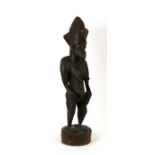 Tribal / African art. A carved wooden African female fertility figure, 64cm (25ins) high.