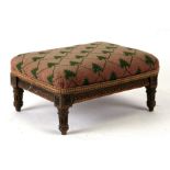 A late 19th century walnut footstool with upholstered seat, 31cm (12.25ins) wide.