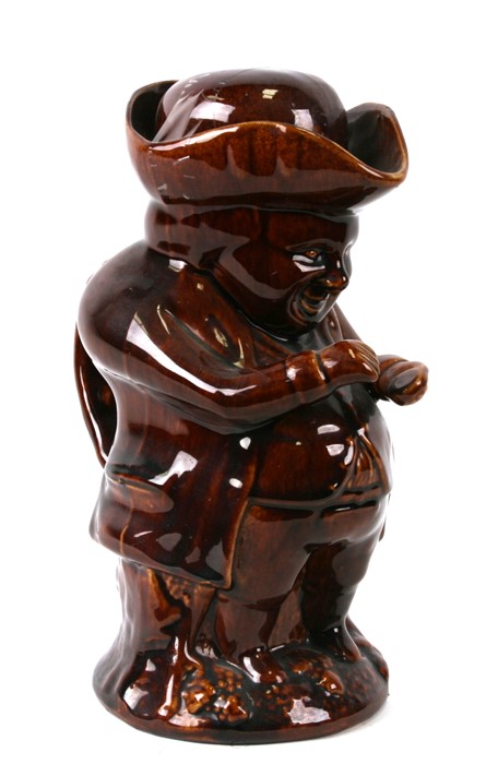 A 19th century Staffordshire treacle glaze character jug, in the form of the snuff taker, 25cm (9.