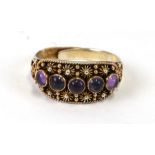 A Chinese silver gilt dress ring, set with amethyst coloured cabochons