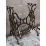 A cast iron Singer treadle sewing machine table, 55cms (21.5ins) wide.