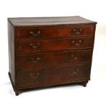 An early 19th century oak chest with four graduated long drawers standing on turned feet, 102cm (