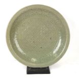 A large Chinese Longquan Ming Dynasty celadon glaze charger, 47cm (18.5ins) diameter. Given as a