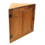 A stripped pine wall handing corner cupboard, 65cm (25.5ins) wide