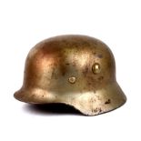 A post WW2 German steel helmet with turned under edge. Complete with leather liner marked M-1943 and