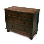 An oak chest of two short and two long graduated drawers, 99cm (39ins) wide.