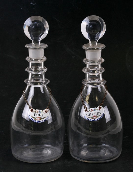 A pair of Georgian glass decanters of small proportions; together with enamel Port and Sherry bottle